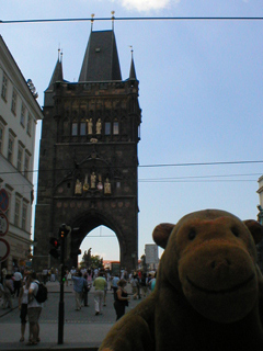 Mr Monkey looking at the Old Town Tower on Charles Bridge