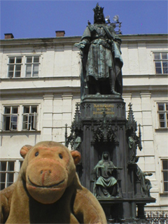 Mr Monkey looking at the statue of Charles IV in the Knights of the Cross Square