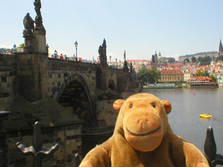 Mr Monkey looking at Charles Bridge from the riverside