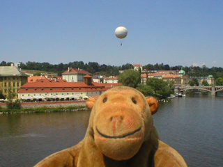 Mr Monkey looking downriver from the Charles Bridge