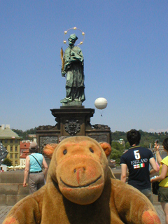 Mr Monkey looking at the statue of St John Nepomuk