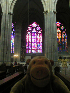 Mr Monkey looking at stained glass across the nave