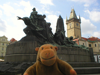 Mr Monkey looking at the back of the Jan Hus monument