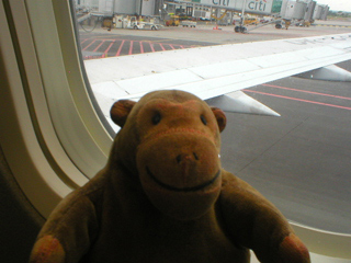 Mr Monkey looking out of his plane at Prague airport
