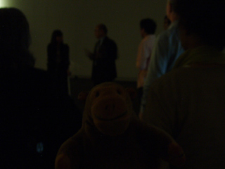 Mr Monkey listening to a talk about the exhibition