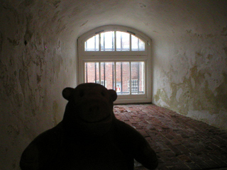 Mr Monkey looking at one of the embrasures in the wall of the keep