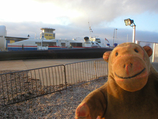 Mr Monkey looking at a hovercraft at rest