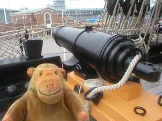 Mr Monkey looking at the carronade on the forecastle