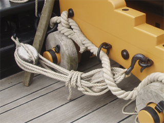 The ropes holding a 12 pounder in place on the forecastle