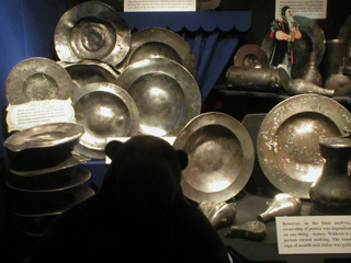 Mr Monkey looking at a display of metal plates from the Mary Rose