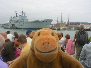 Mr Monkey looking at HMS Ark Royal from the tour boat