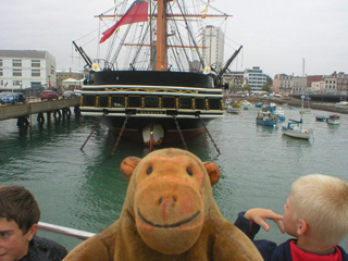 Mr Monkey looking at the stern of HMS Warrior