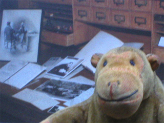 Mr Monkey in front of a picture of Conan Doyle's desk