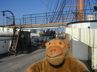 Mr Monkey looking at the bridge of HMS Warrior