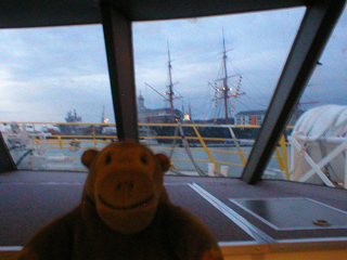 Mr Monkey looking at HMS Warrior from the catamaran