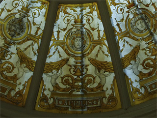 A glass section of dome with a face representing April