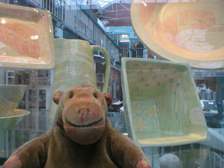 Mr Monkey looking at plates and bowls by Vivienne Ross
