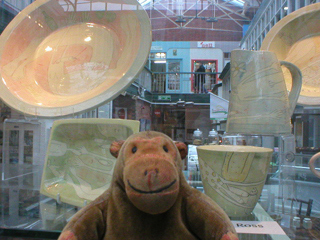 Mr Monkey looking at plates and bowls by Vivienne Ross