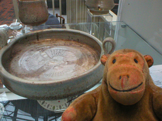 Mr Monkey looking at a platter by Sally Raven