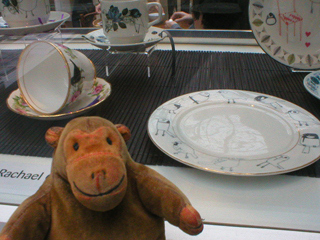Mr Monkey looking at painted plates by Rachael Gardiner