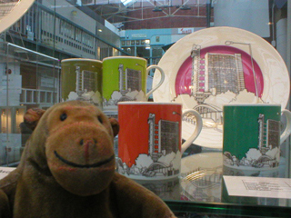 Mr Monkey looking at plates and mugs showing Trellick Tower by People Will Always Need Plates