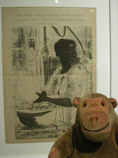Mr Monkey looking at a poster showing a black woman washing dishes