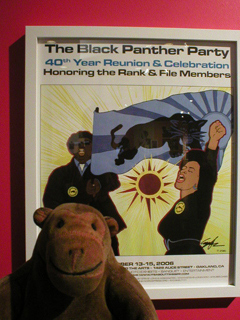 Mr Monkey looking at the Black Panther Party 40th Year Reunion poster