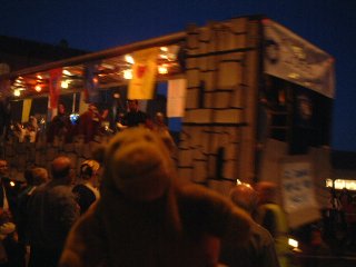 Mr Monkey in a crowd, with a float passing