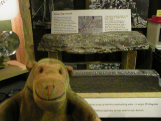 Mr Monkey looking at a large lump of Roman lead