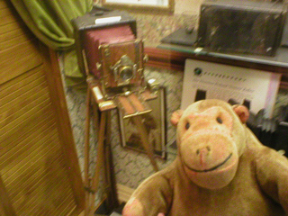 Mr Monkey looking at a Victorian camera
