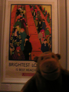 Mr Monkey looking at a 1924 Underground poster