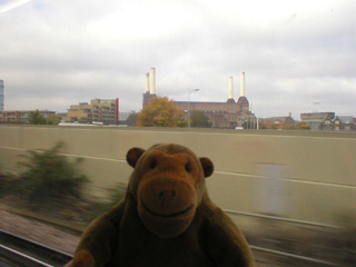 Mr Monkey looking looking at Battersea power station from a train