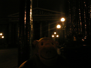 Mr Monkey looking at the British Museum at night