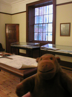 Mr Monkey looking at a drawing office