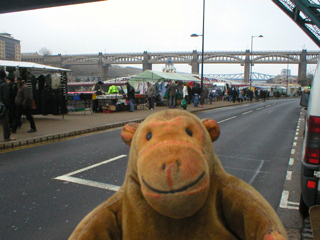 Mr Monkey looking at the Sunday Market and the High Level Bridge