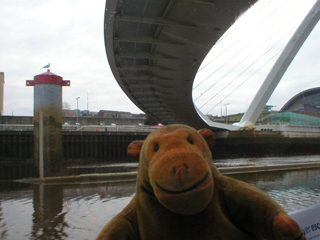 Mr Monkey looking at Millennium Bridge from below