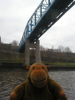 Mr Monkey looking at the Queen Elizabeth II Bridge from below