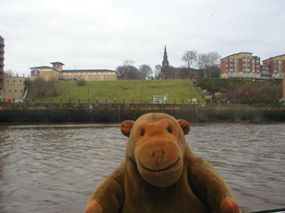 Mr Monkey looking at St Ann's church from the river