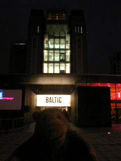 Mr Monkey outside the Baltic in the dark