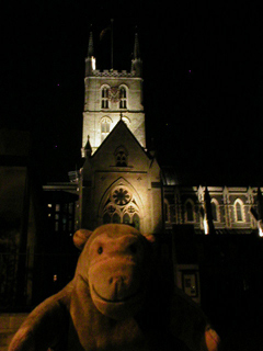 Mr Monkey passing Southwark Cathedral at night