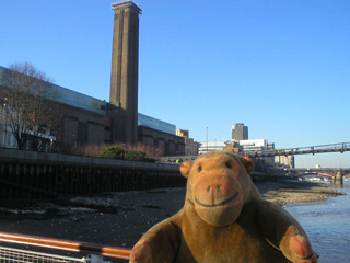 Mr Monkey looking at the Tate Modern from Bankside Pier