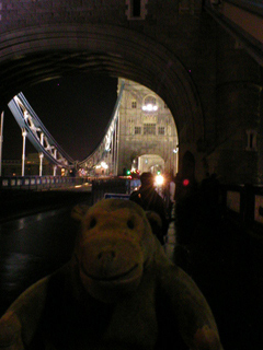 Mr Monkey crossing Tower Bridge at night