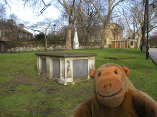 Mr Monkey looking at a tomb in Hackney churchyard