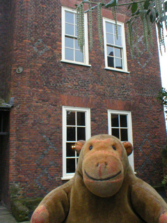 Mr Monkey looking at the brickwork of Sutton House