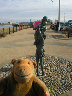 Mr Monkey looking at the Welcome Home sculpture
