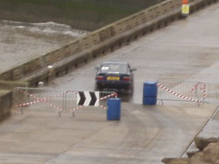 A rally car going through the gate at the end of the run