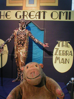 Mr Monkey looking at a sculpture of the Great Omi