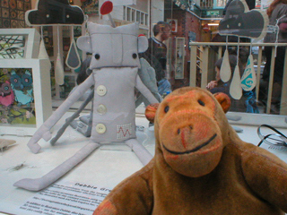 Mr Monkey looking at a cuddly robot made by Debbie Greenaway
