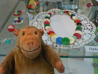 Mr Monkey looking at necklaces by Ophelia Button