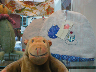 Mr Monkey looking at tea cosies by Molly's Mum